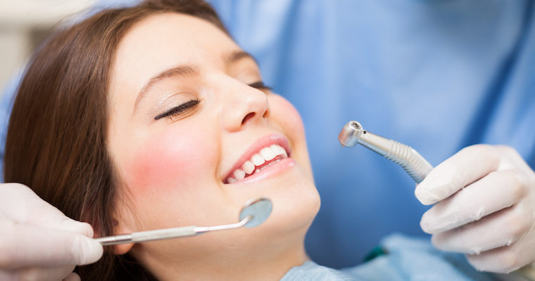 Woman Getting Her Teeth Cleaned at Dentist