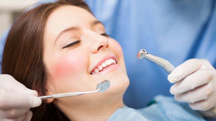 Woman Getting Her Teeth Cleaned at Dentist